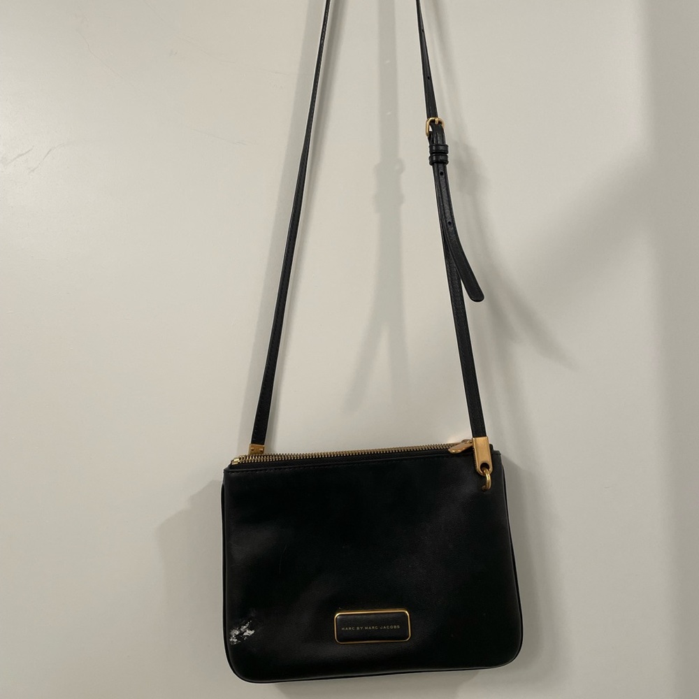 Marc by Marc Jaocobs black leather crossbody with gold hardware accents.